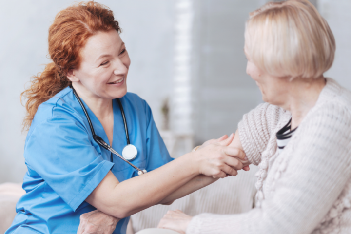 Happy nurse checking on a patient