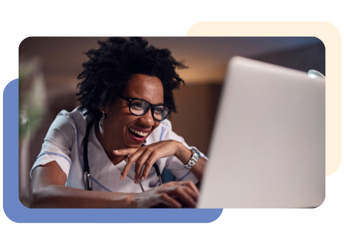 Happy black female doctor surfing the internet on laptop.